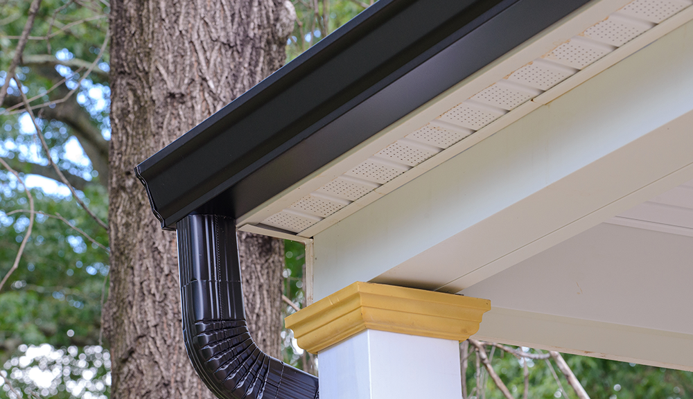 Gutter and downspout on a porch corner
